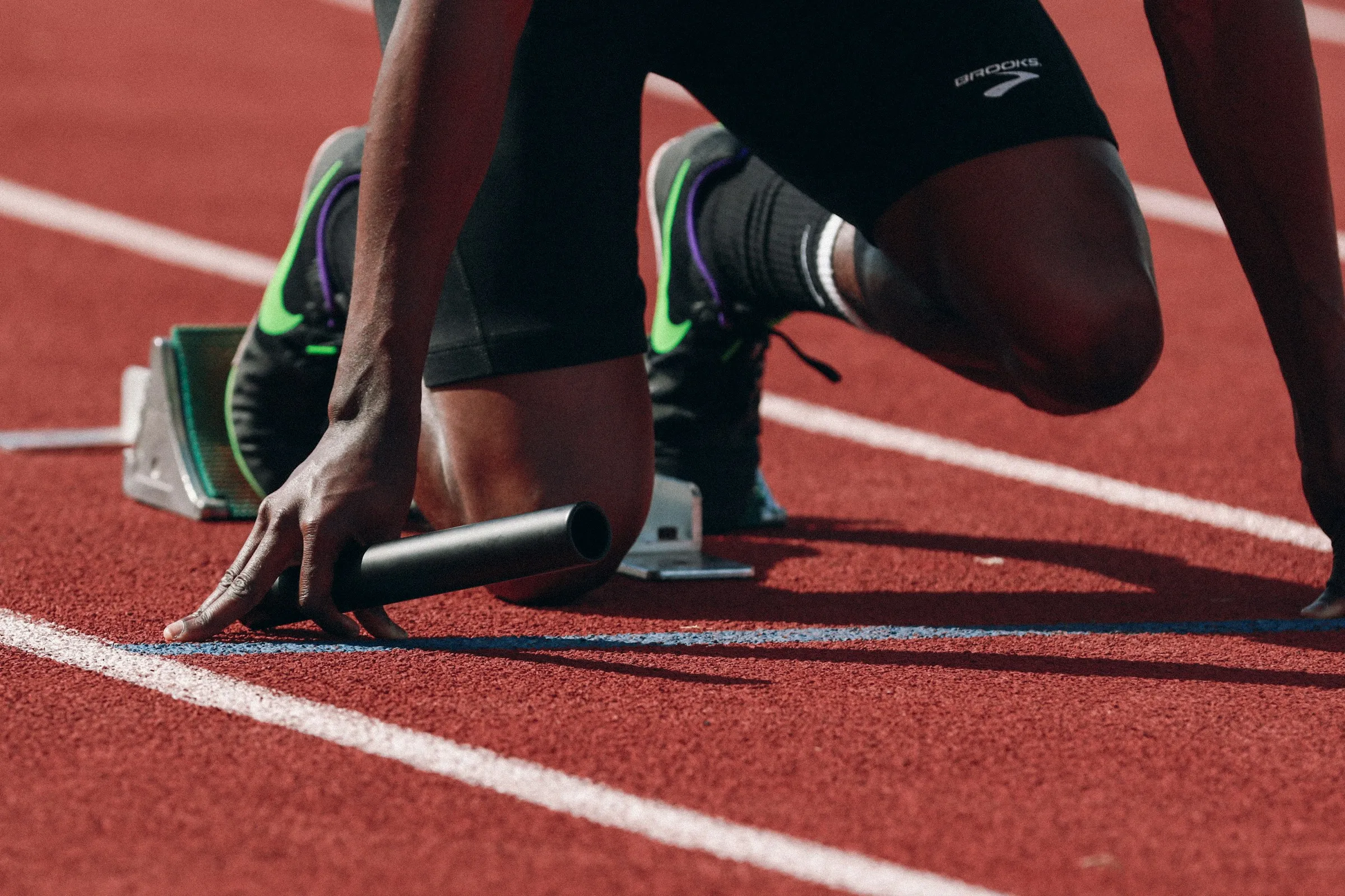 A sprinter's hands on the start line