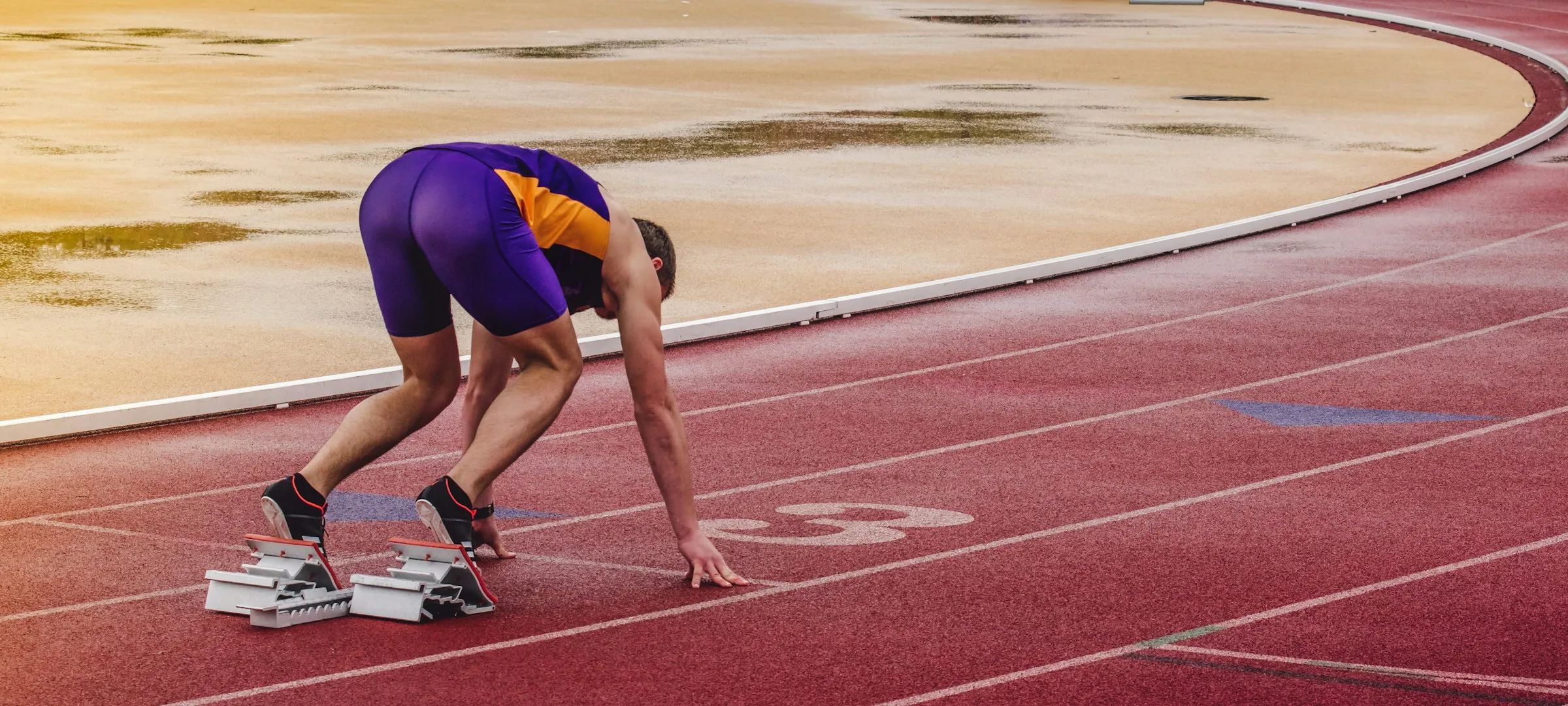 A sprinter in the set position in the blocks