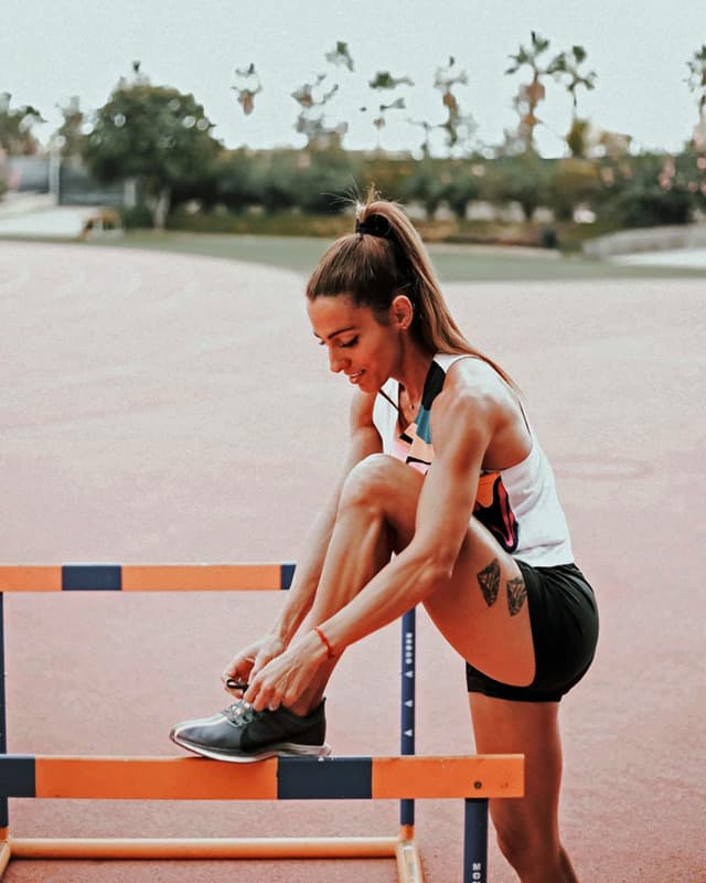 Ivet Lalova Collio tieing shoelace at track