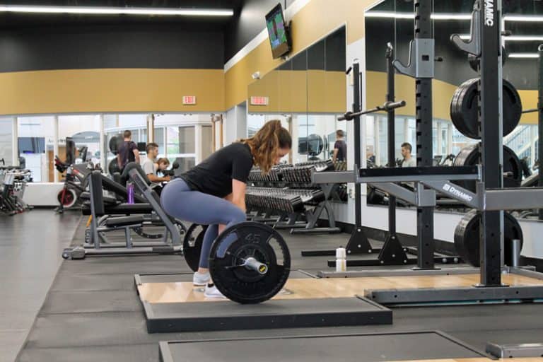 Woman performing a Deadlift during a training session